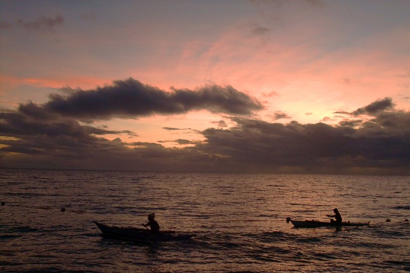 Fishermen leave shore to begin a night of fishing